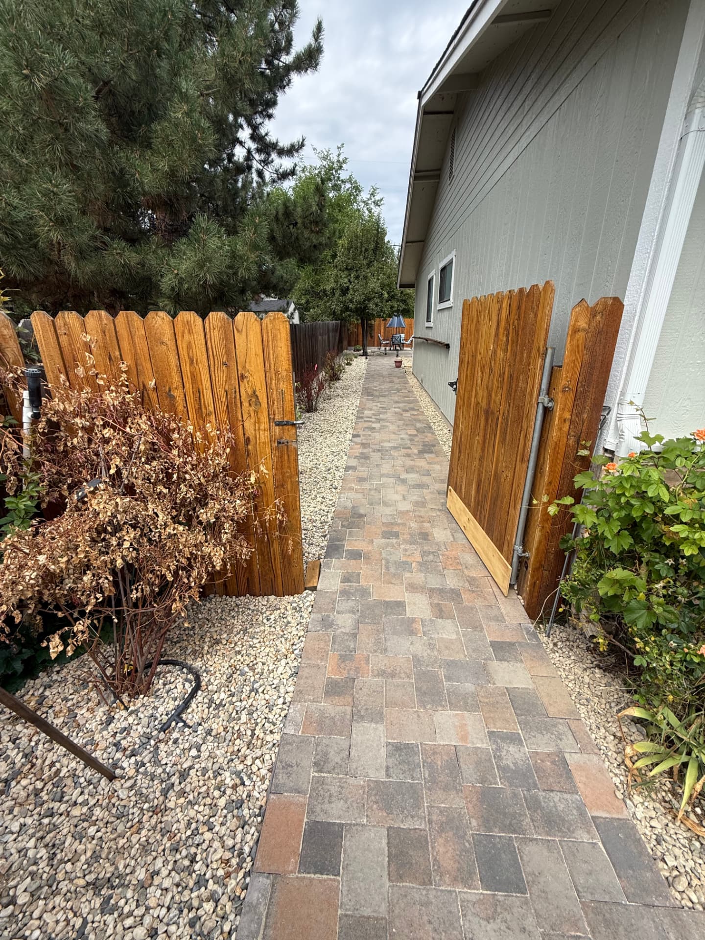 Paver side walkway with gravel borders and new gate