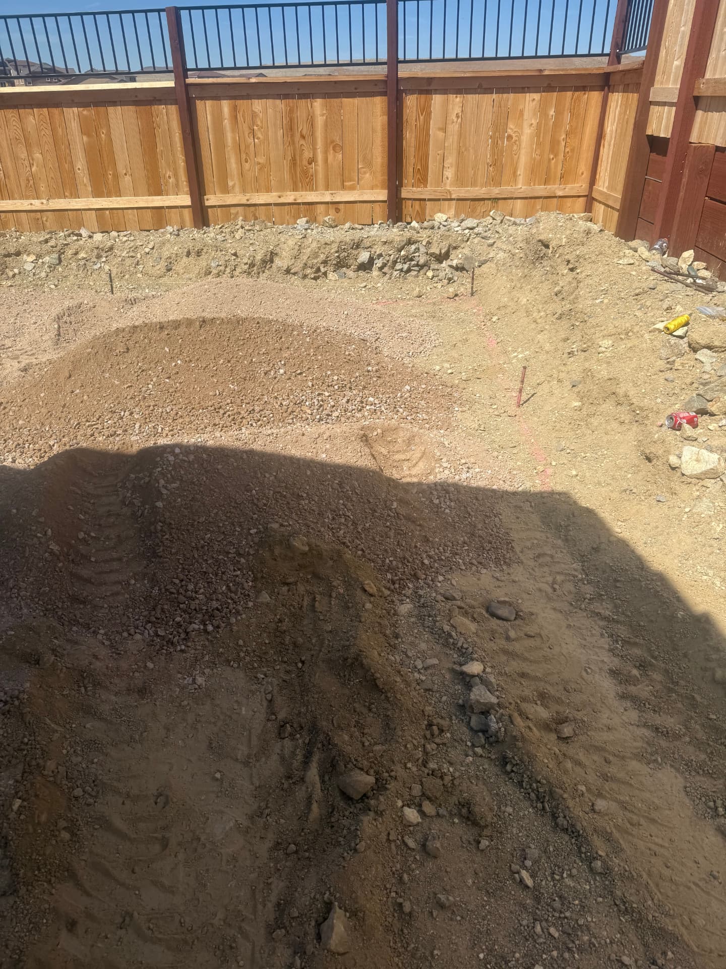 Excavated patio area with base material staged and layout marked