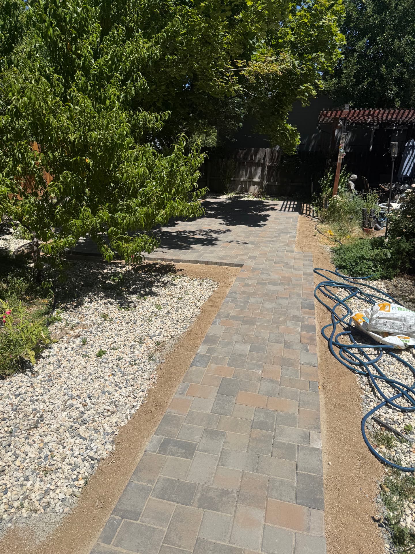 Paver walkway leading to a new patio during installation
