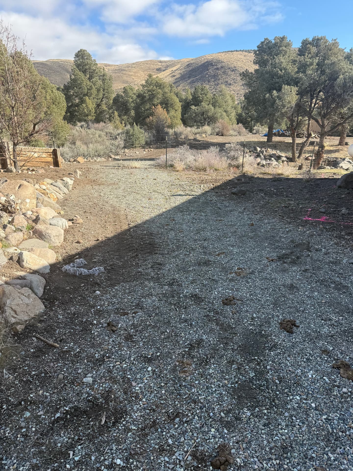 Graded gravel driveway area with mountain views before hardscape work