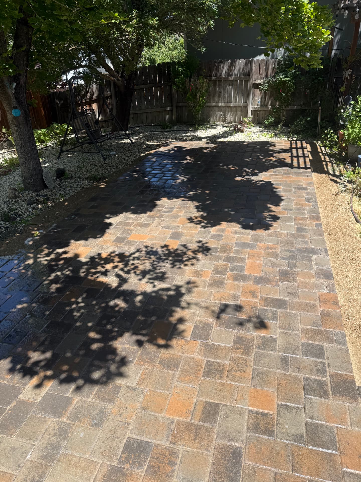 Freshly laid paver patio being washed down