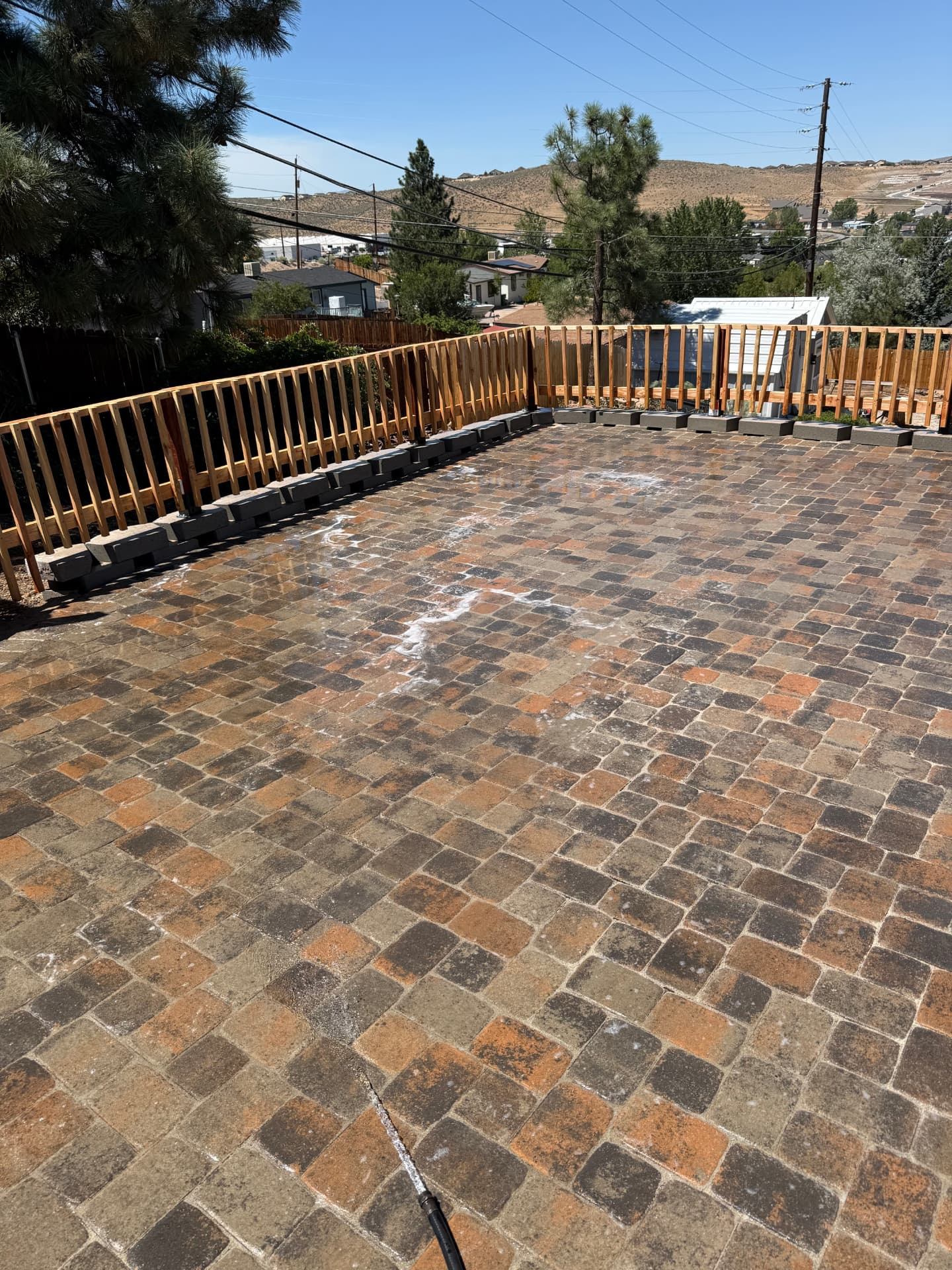 Finished paver patio with cedar railing and block wall from above