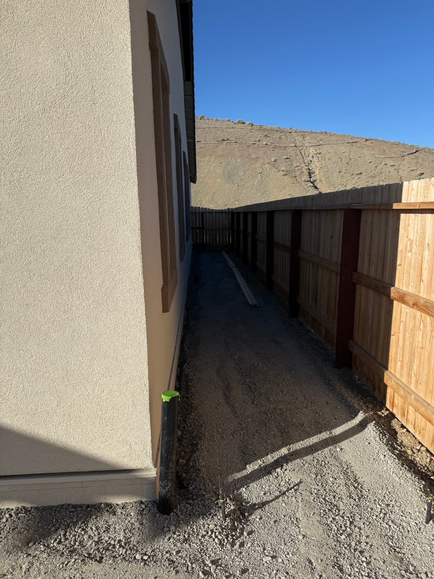 Side yard compacted and graded for the new concrete walkway