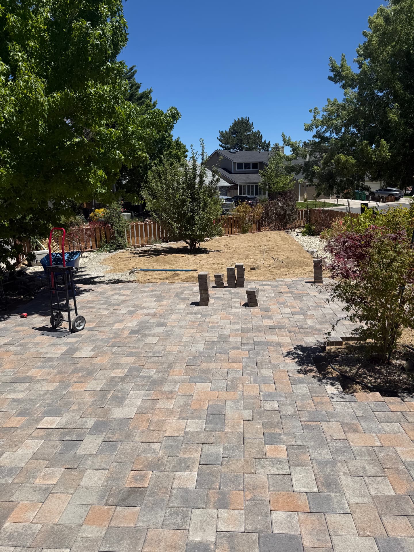 Wide paver patio with base material prepped for the next phase