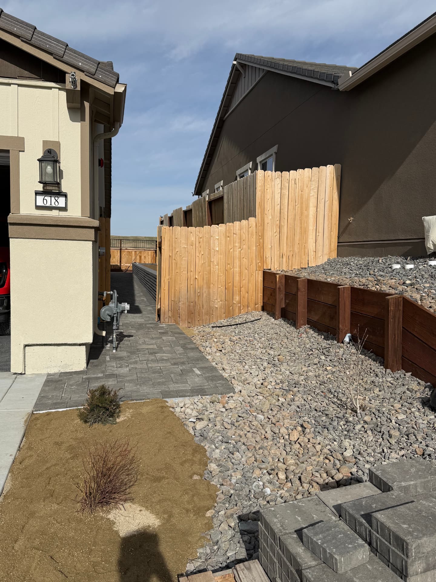 Completed side yard paver walkway with rock landscaping