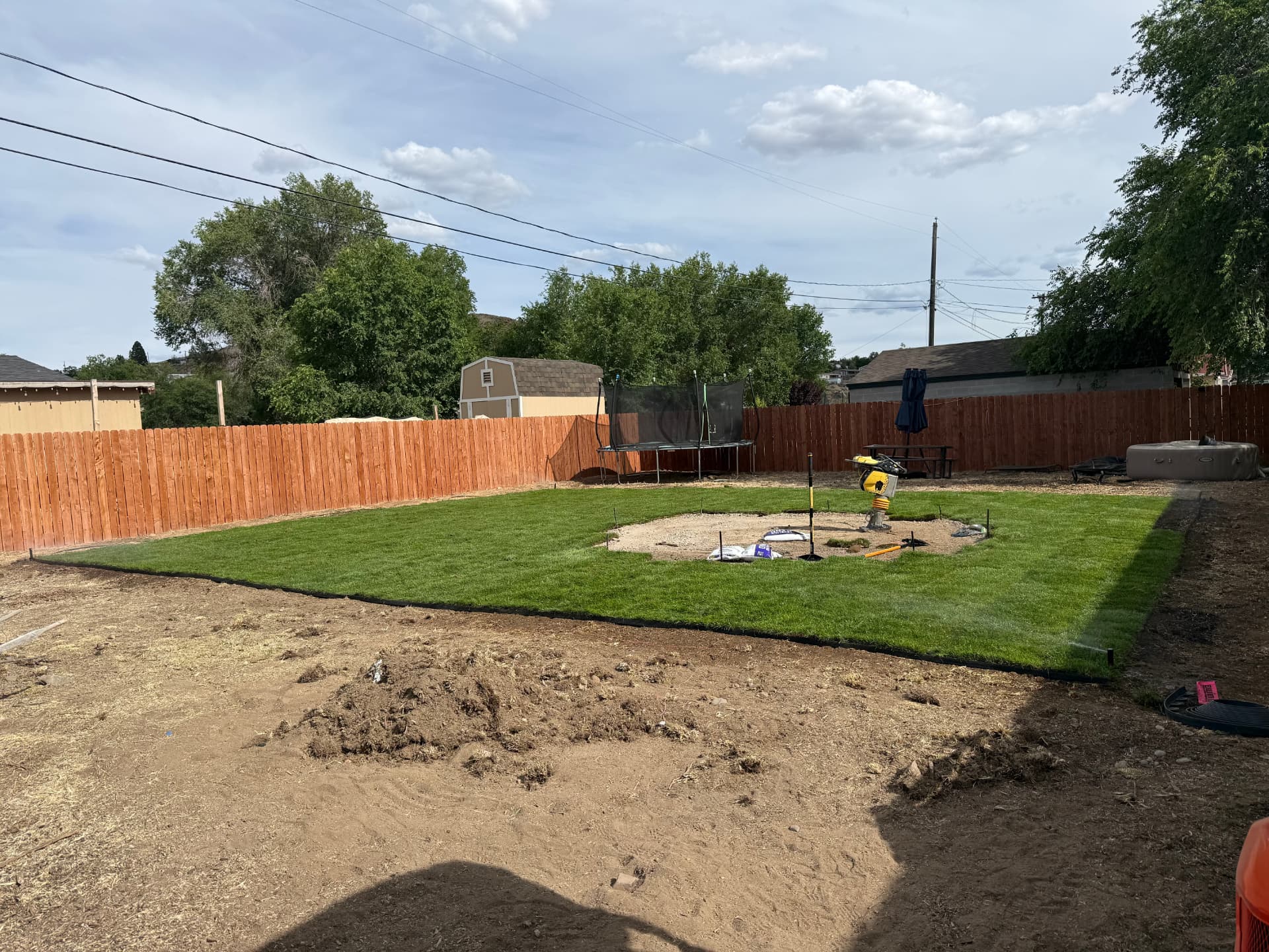 New lawn and patio base ready for paver installation