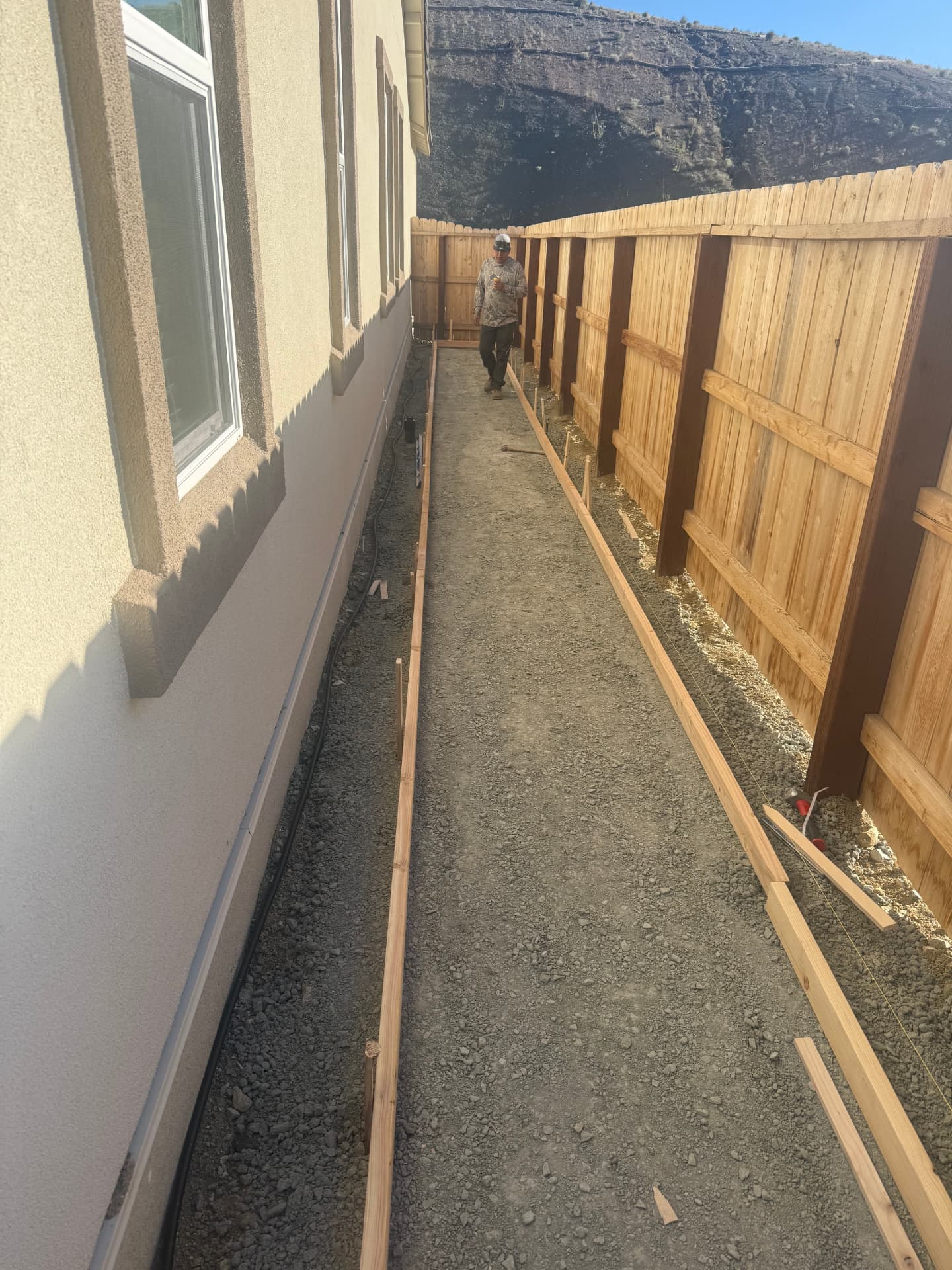 Wood forms set for the side yard concrete walkway