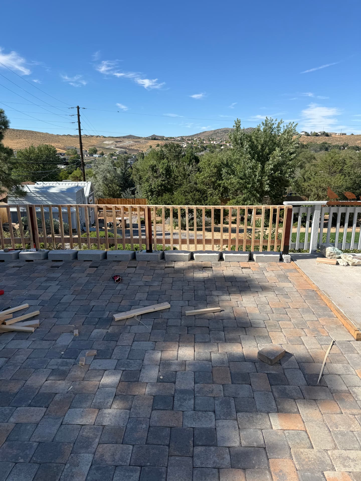 Paver patio with new cedar railing installed during the build