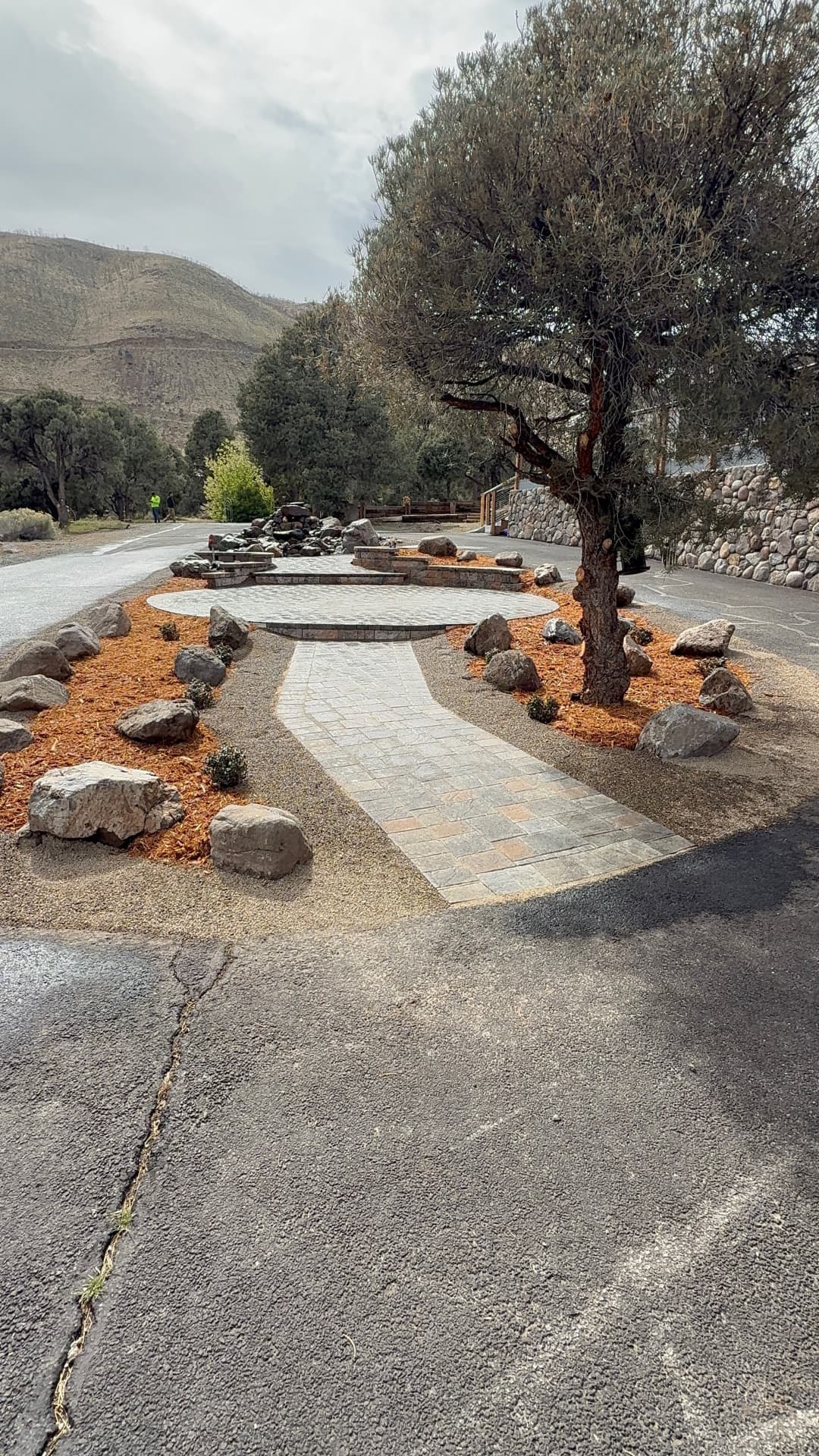 Finished walkway leading to the circular patio with mulch and boulder beds