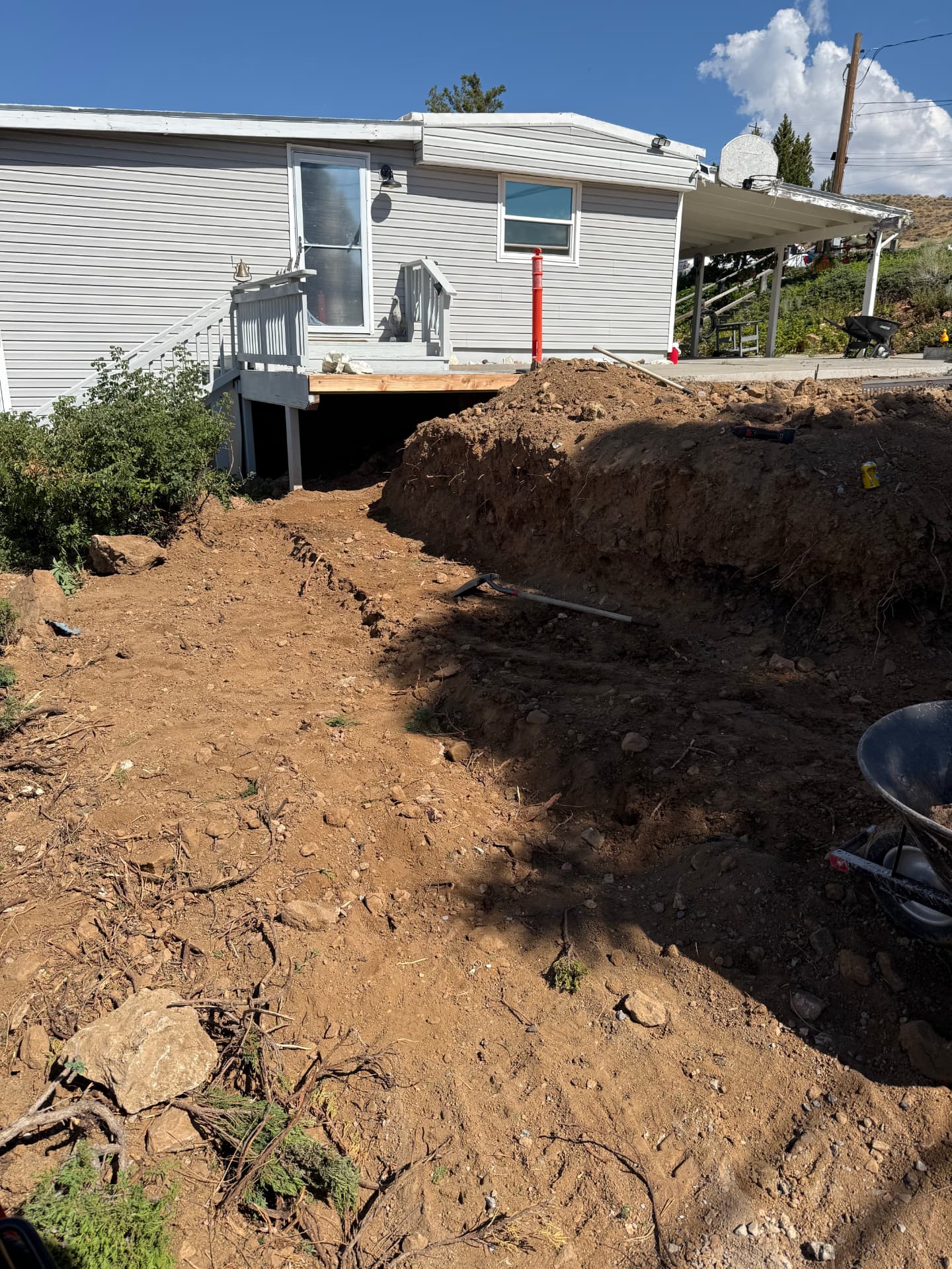 Grading and excavation alongside the house mid-project