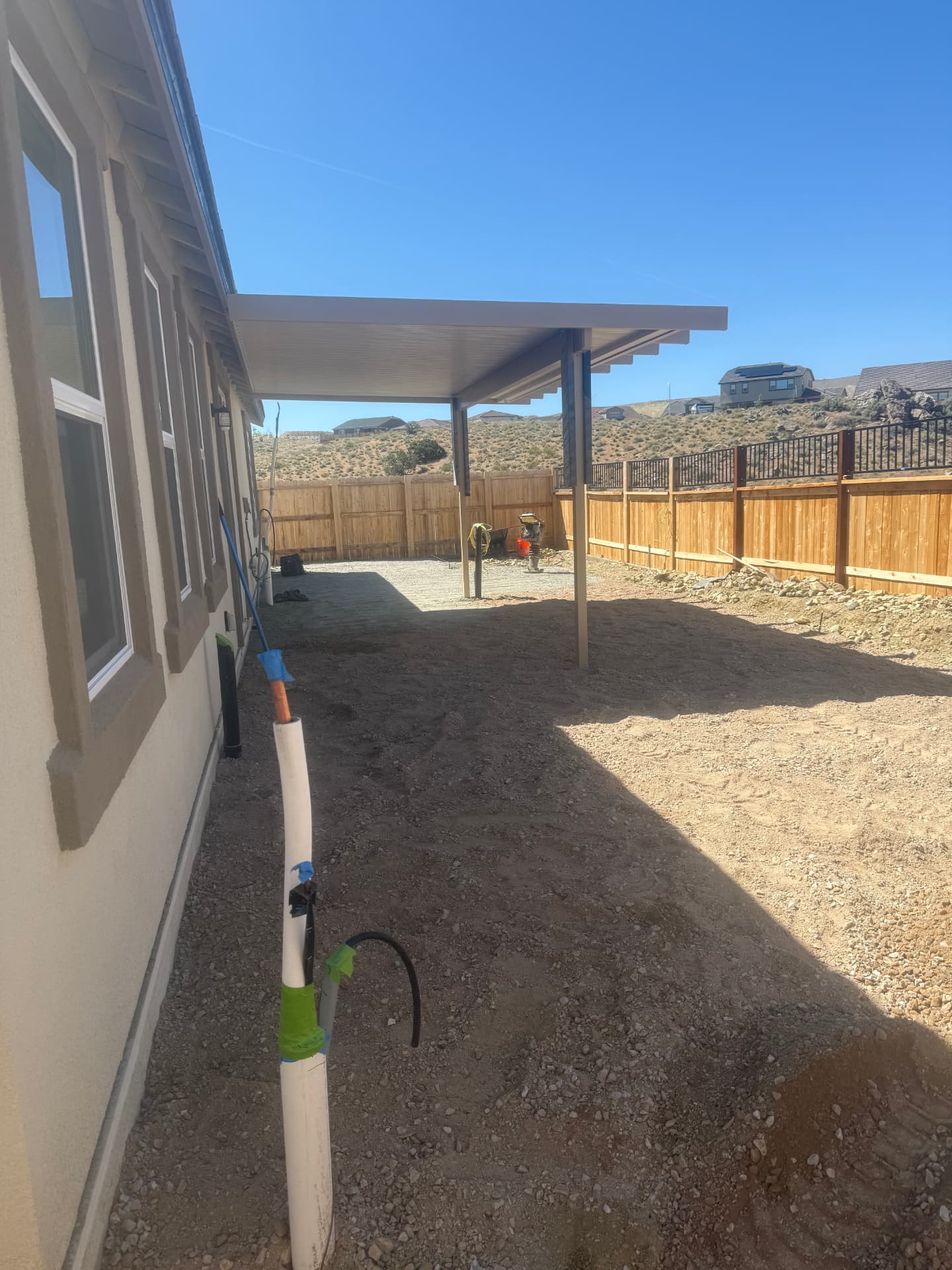 Graded backyard under the new patio cover ready for base