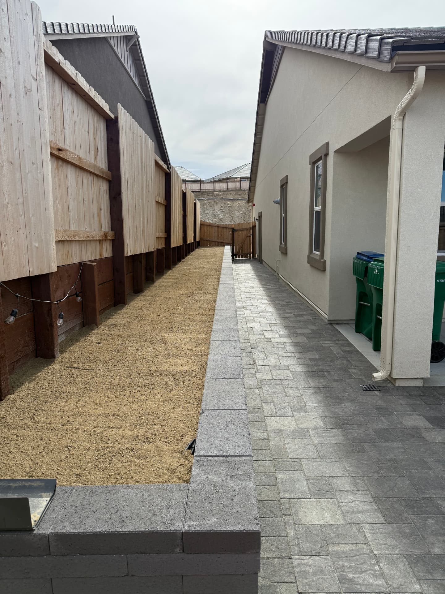 Long finished side yard paver path between the houses