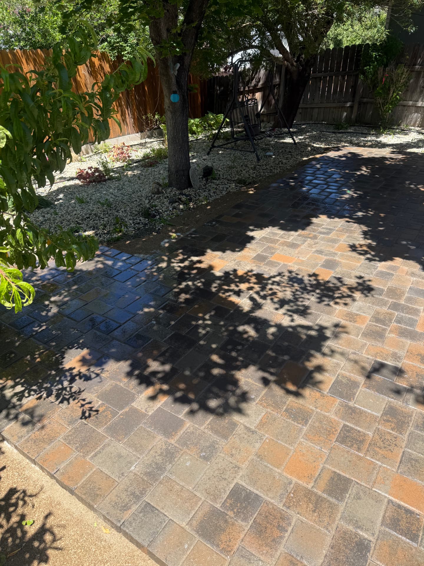 Paver patio with decorative rock border taking shape