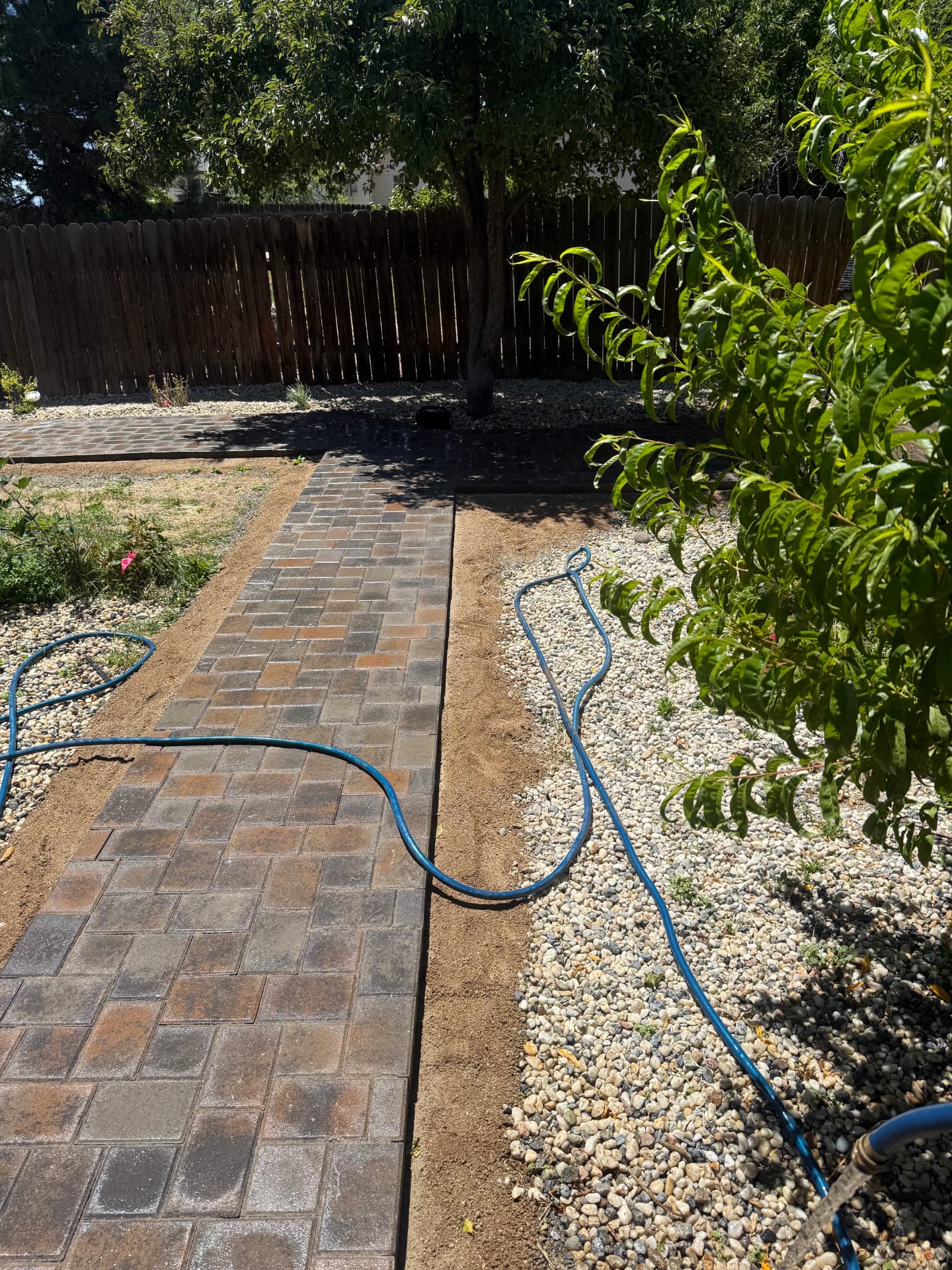 Paver pathway with rock beds installed alongside